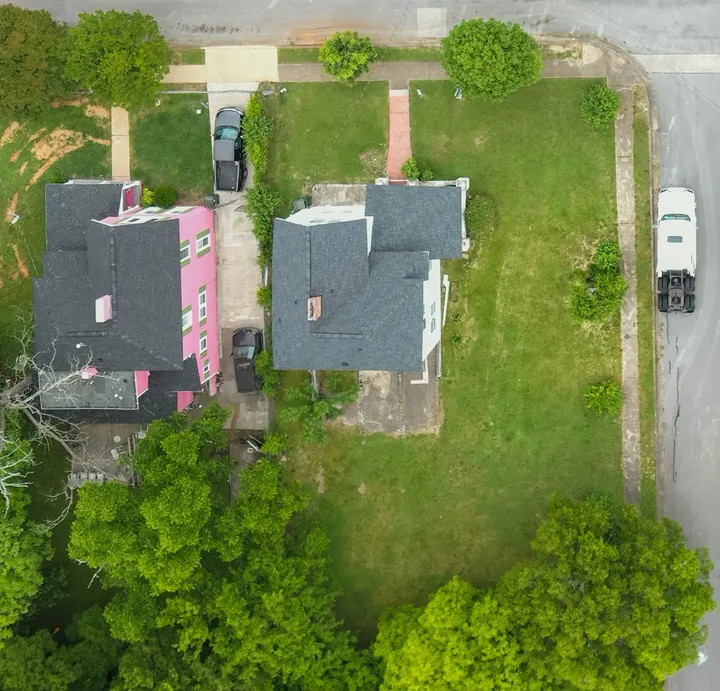 Aerial photo of a corner lot with a house, front walk and a large side and rear yard