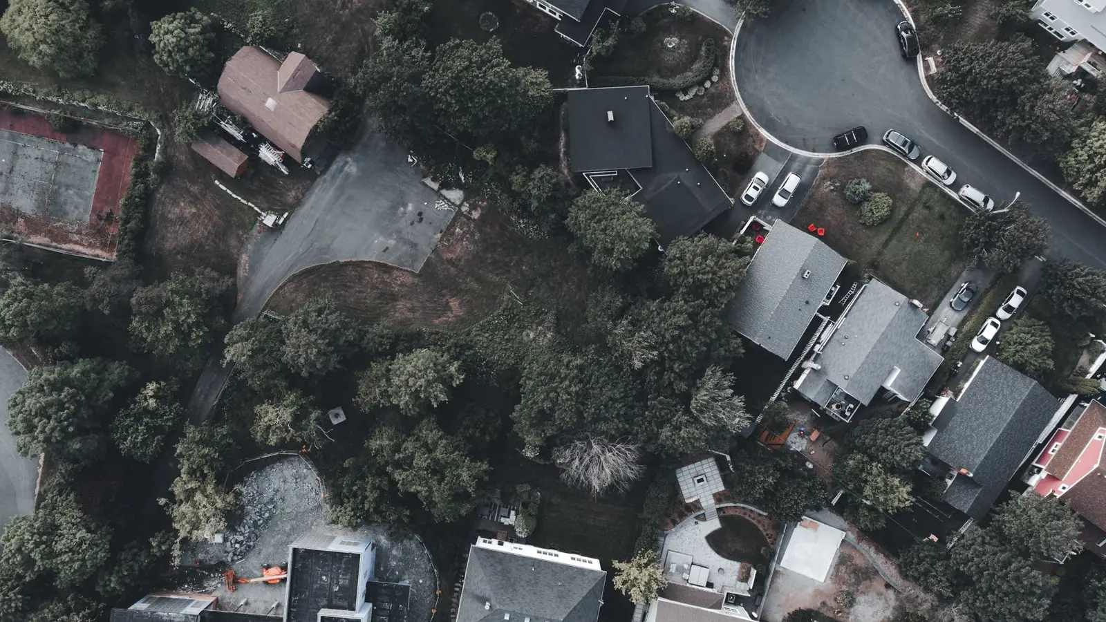 Top-down aerial view of suburban lots, houses and streets